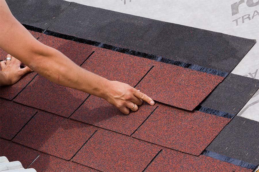 roofer installing roof tiles